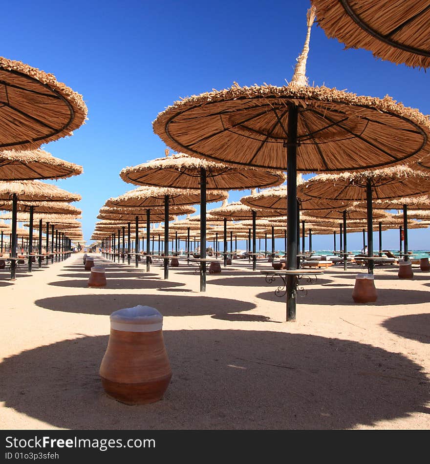 Blue Sky And Umbrellas On The Beach