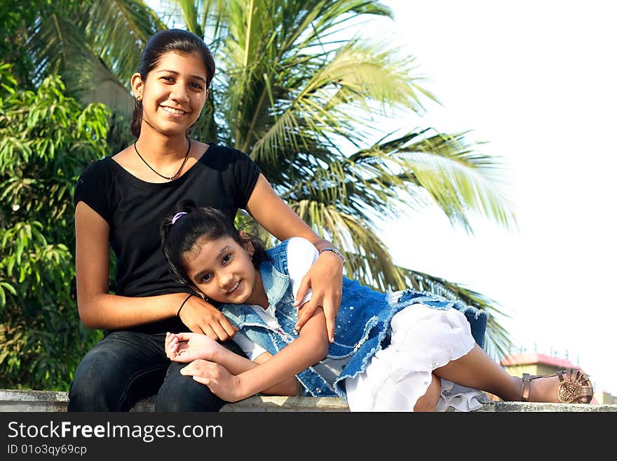 A teenage and a small girl sharing a great rapport. A teenage and a small girl sharing a great rapport.