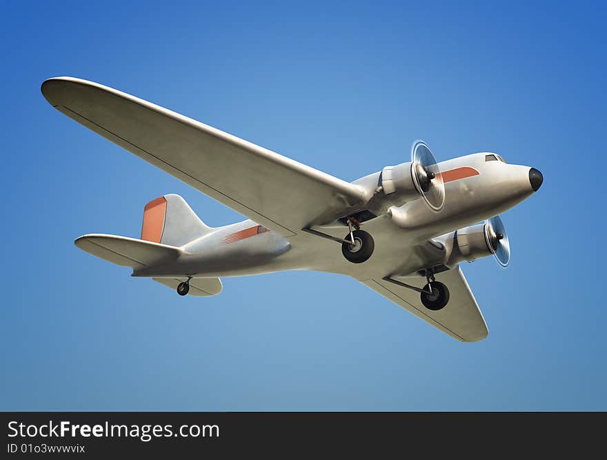 A Shot of a DC3 airplane in flight against a blue sky. A Shot of a DC3 airplane in flight against a blue sky