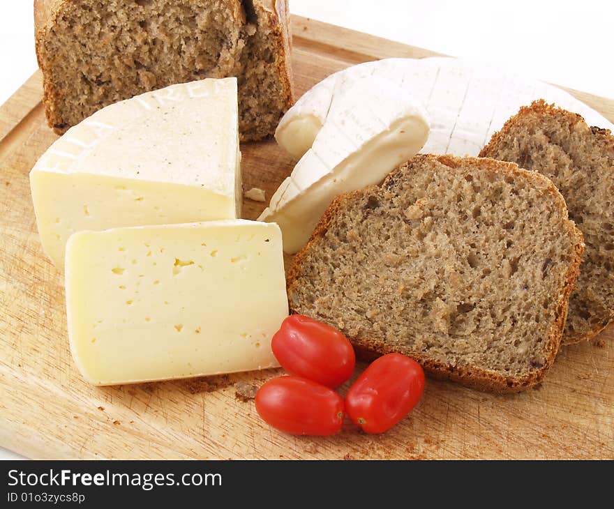 Bread, tomatoes and different cheeses on a white background. Bread, tomatoes and different cheeses on a white background