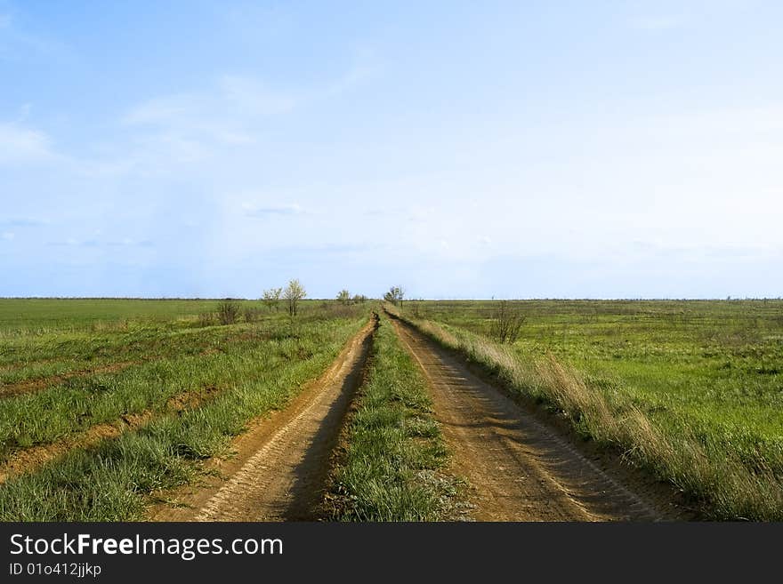 Desert road to horizon and deep blue sky