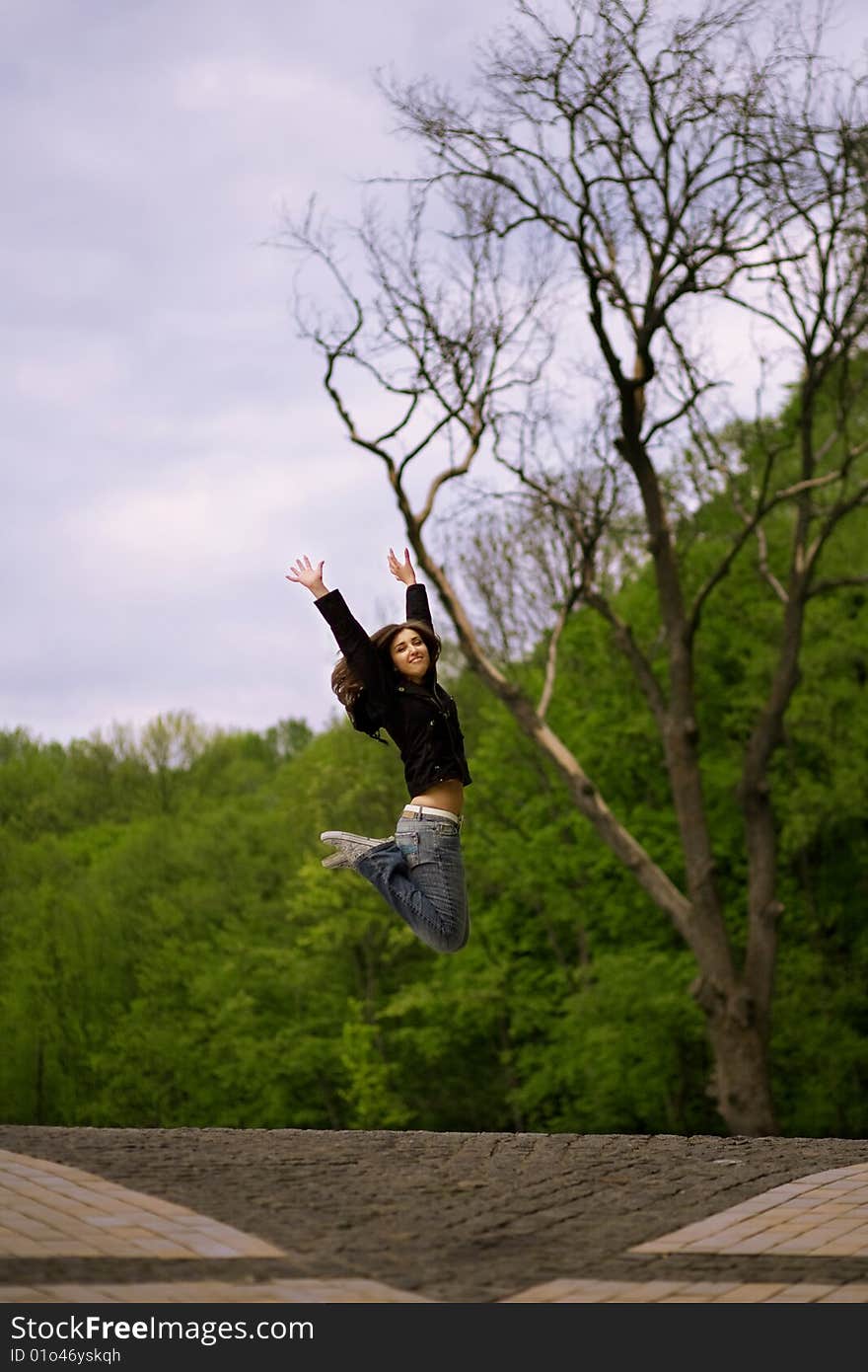 Young girl jumping in park