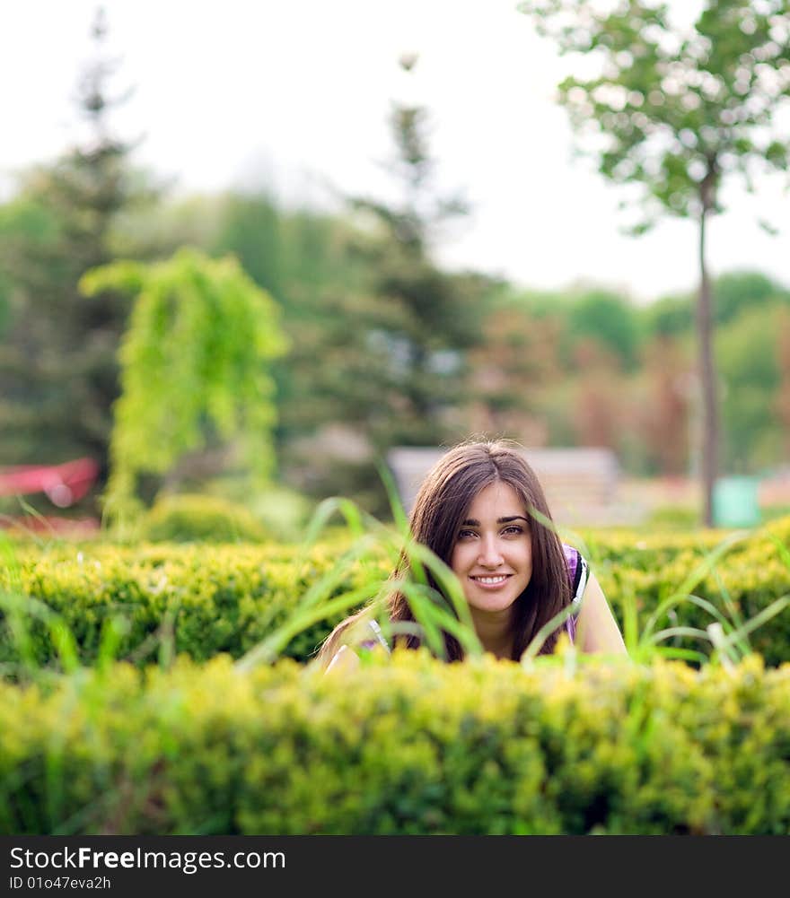 Young girl hiding over bush