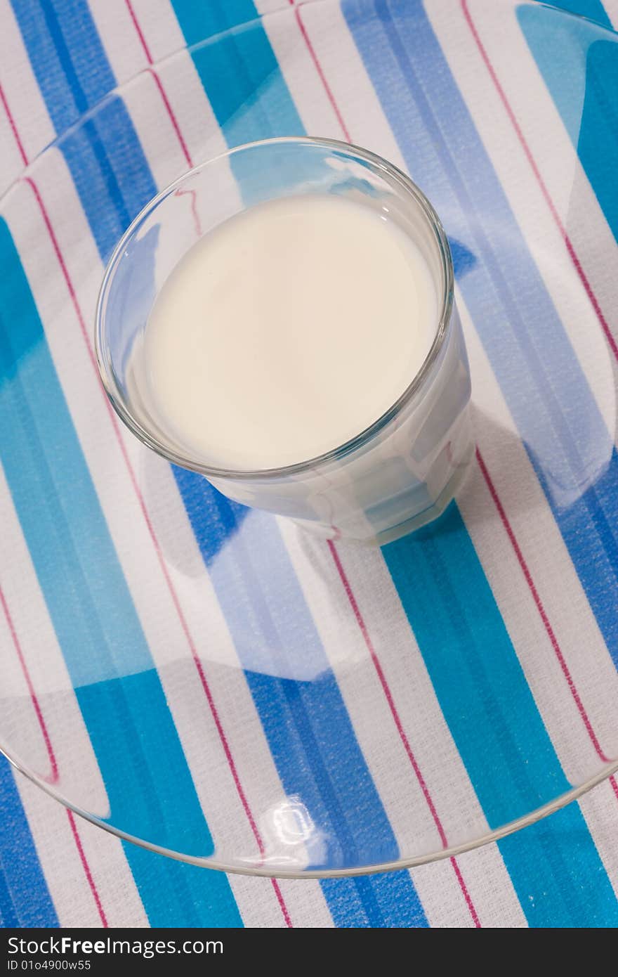 Food series: full glass of milk on stripped table-cloth