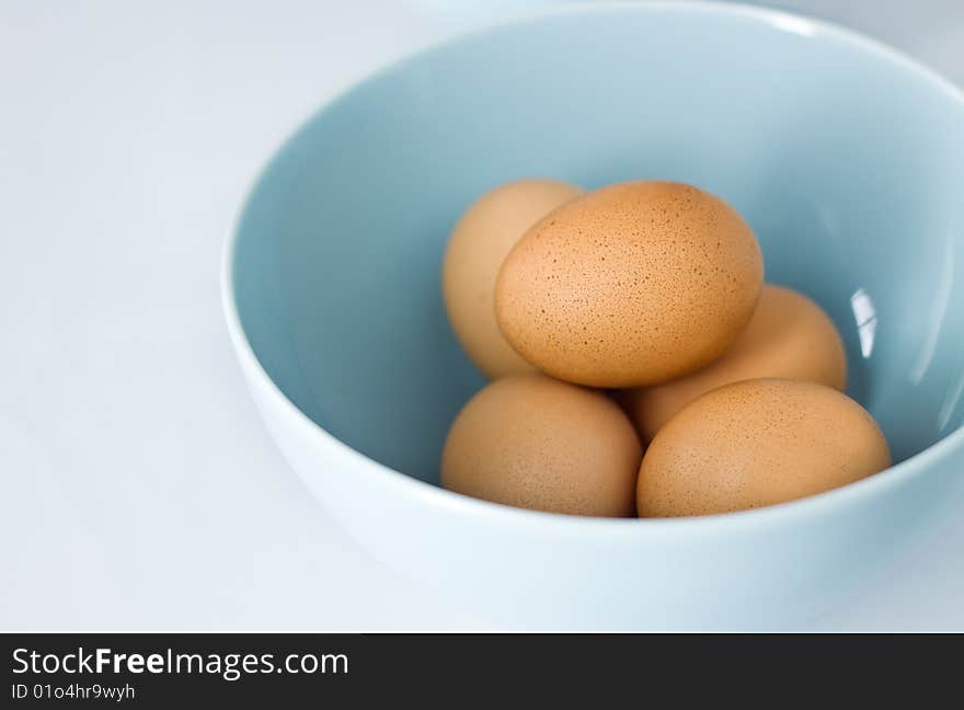 Fresh Brown Eggs in Pastel Blue Bowl