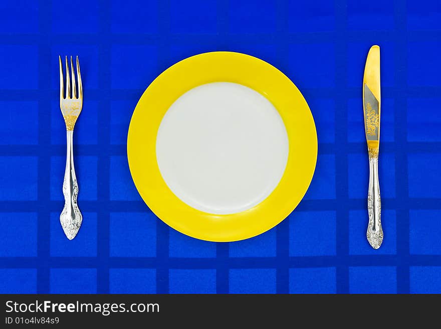 Plate, Knife And Fork On Table Cloth