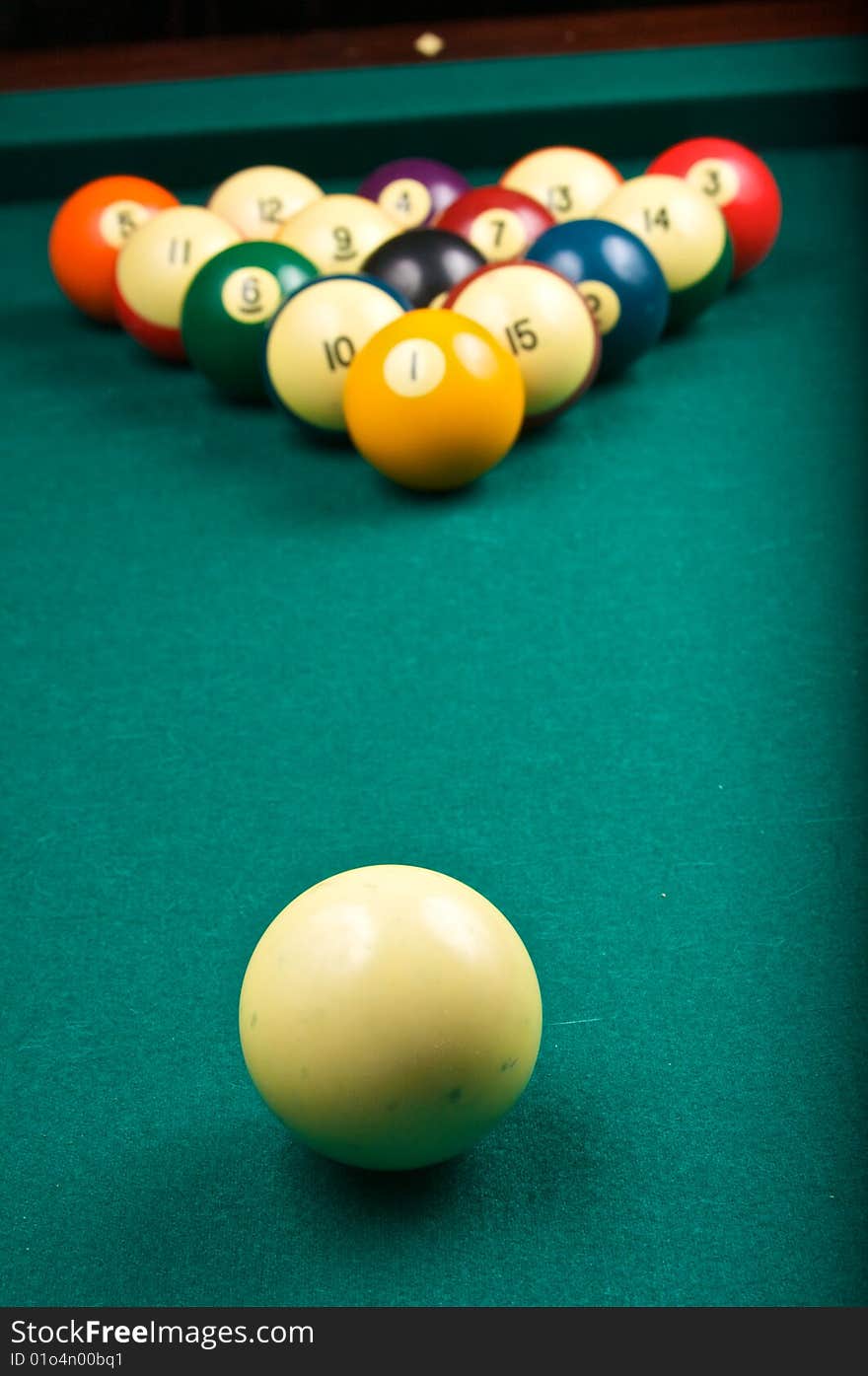 A cue ball is ready to start a game of billiards, focus is on the cue ball. A cue ball is ready to start a game of billiards, focus is on the cue ball