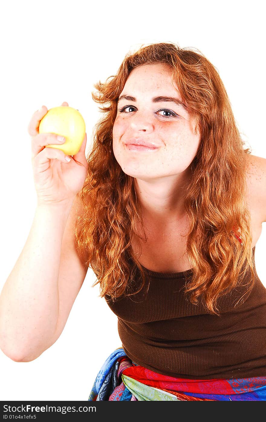 Pretty long red haired girl shows her yellow apple what she just started eating. Pretty long red haired girl shows her yellow apple what she just started eating.