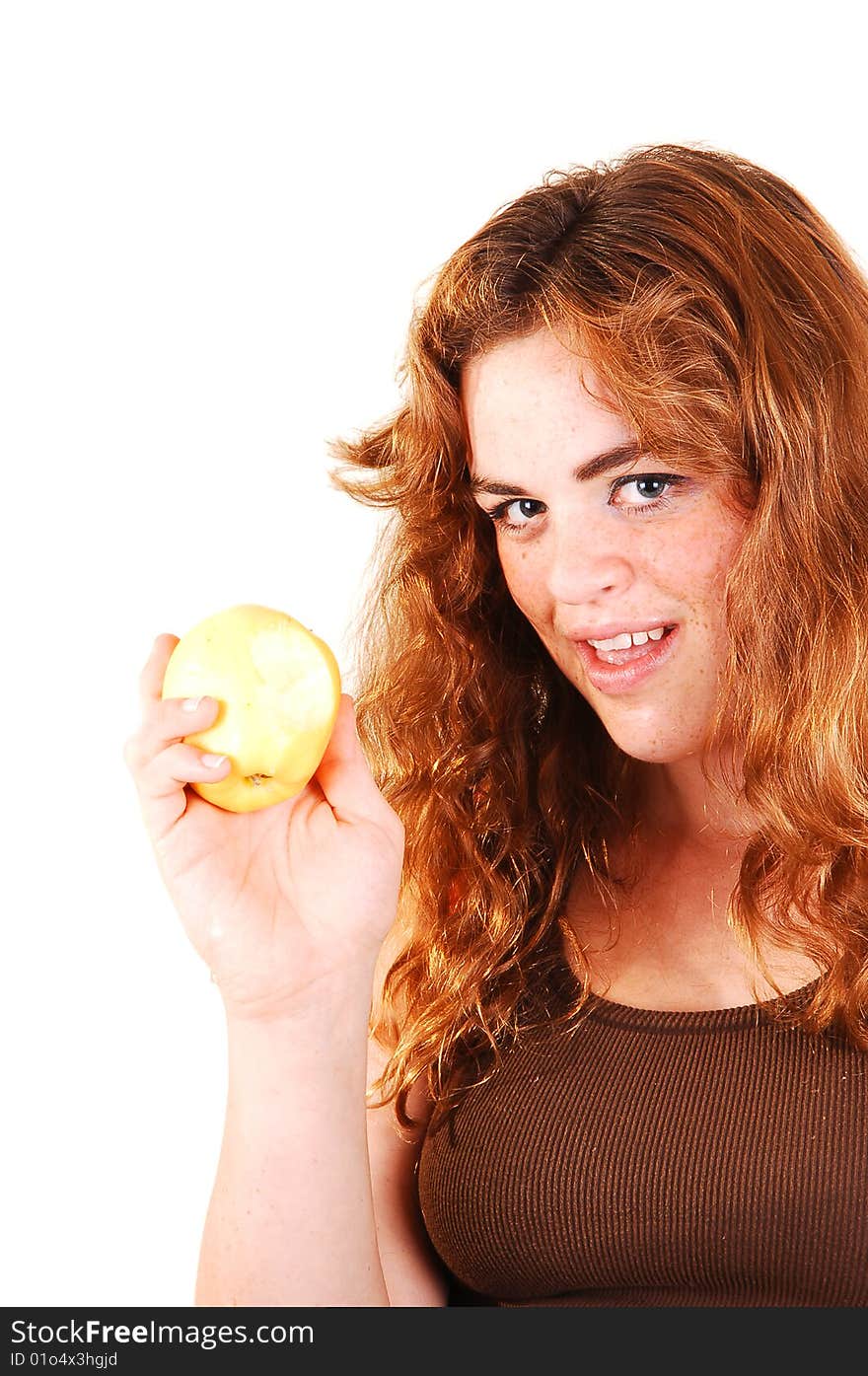 Pretty long red haired girl shows her yellow apple what she just started eating. Pretty long red haired girl shows her yellow apple what she just started eating.