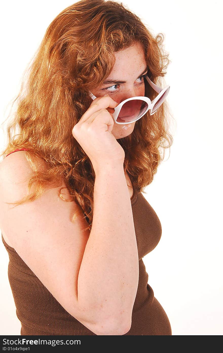 Young girl with sunglasses and long bright red hair and brown top
standing and looking. Young girl with sunglasses and long bright red hair and brown top
standing and looking.