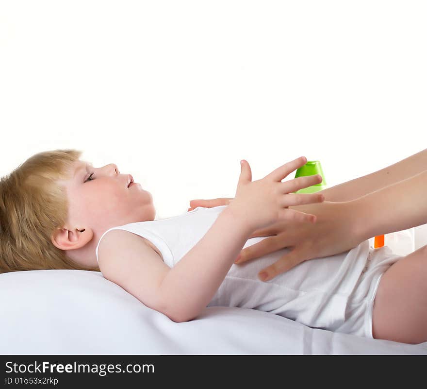 Massage to the small child in a white room. Massage to the small child in a white room