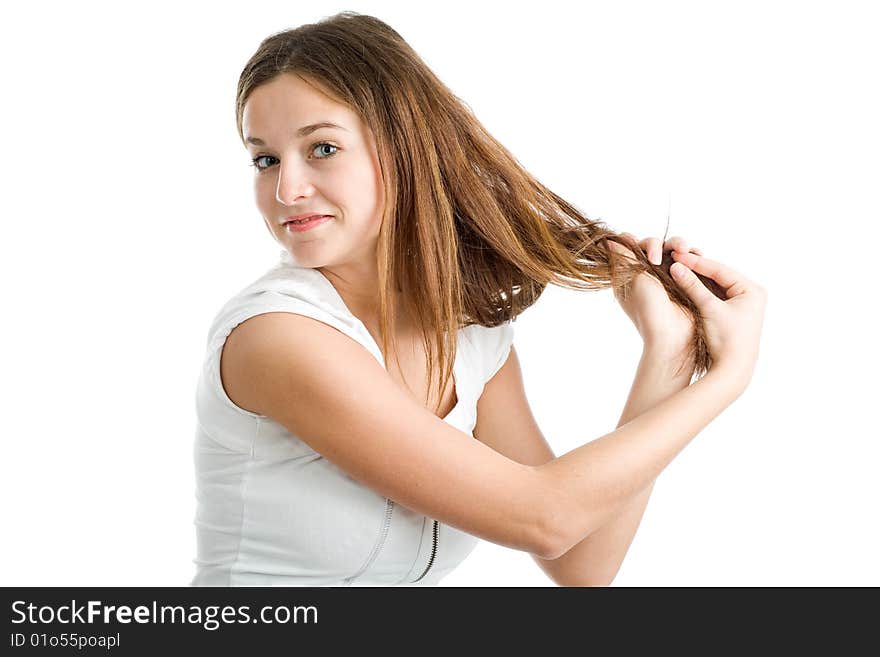 A beautiful young smiling woman with long brown hair posing on a white background