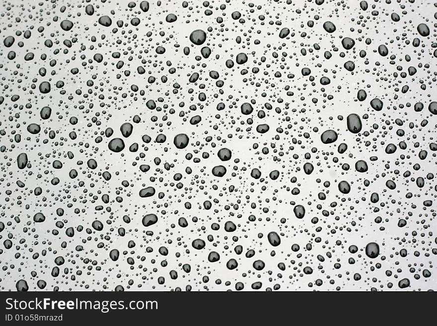 Water drops on the black smooth background