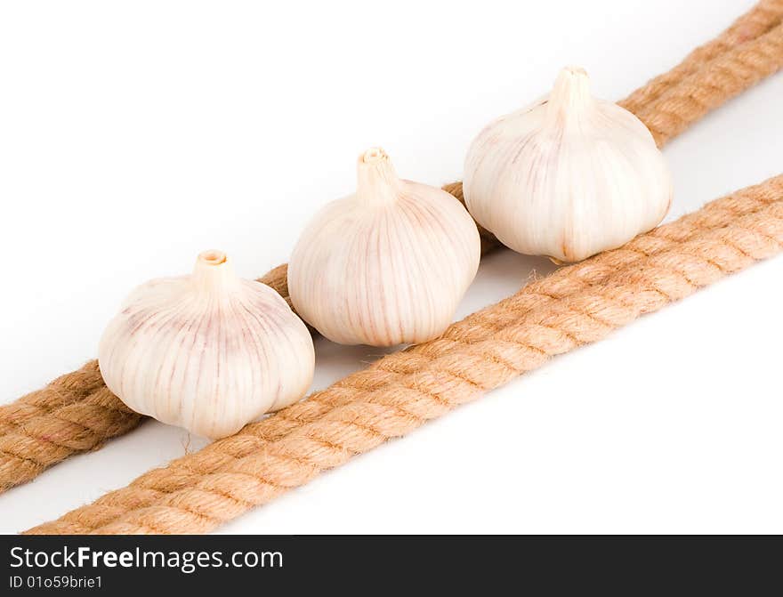 Three bulbs of garlic near the rope