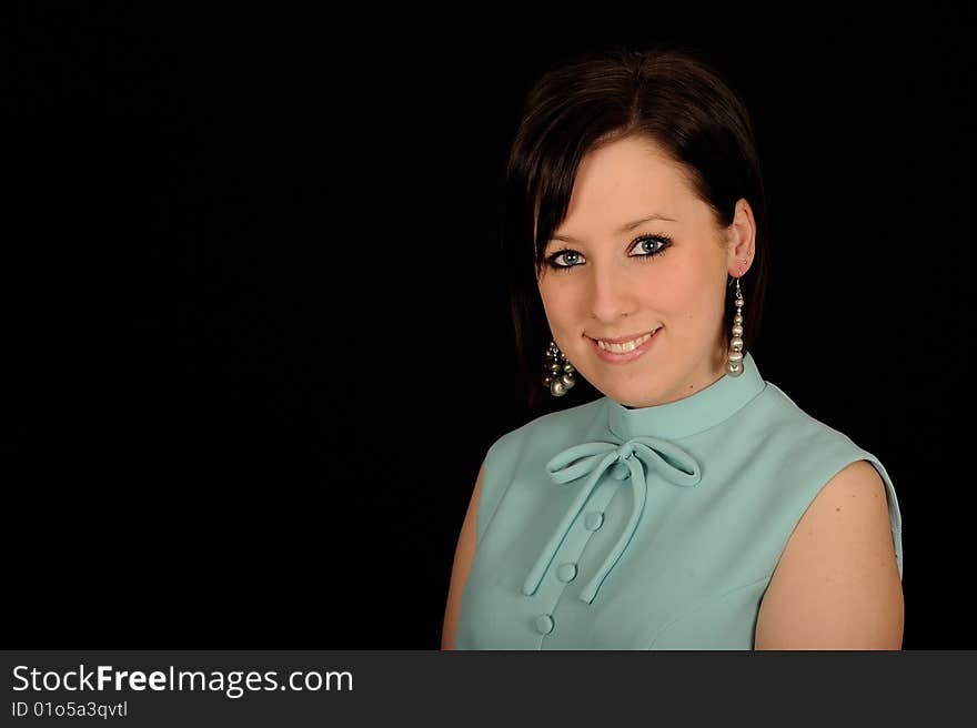 A formal portrait of a dark haired teenage girl. Black background. A formal portrait of a dark haired teenage girl. Black background