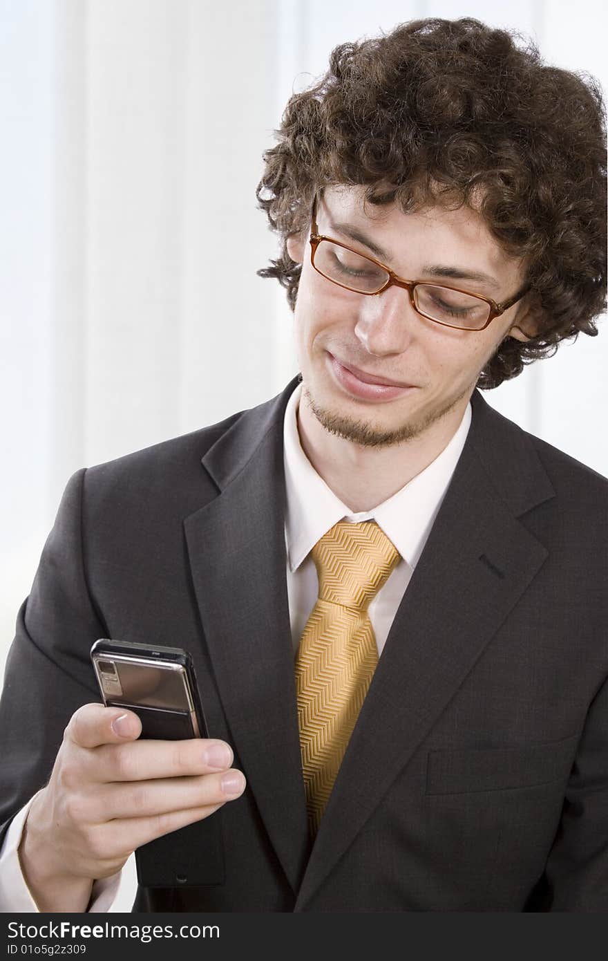 Business man with mobile phone in the office