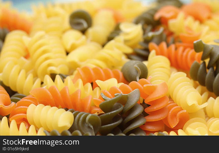 A close up of a three color rotini.