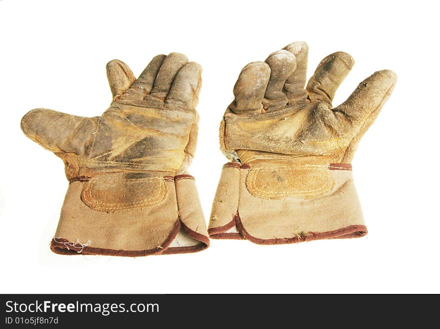 Pair of well worn riggers gloves isolated on white. Pair of well worn riggers gloves isolated on white