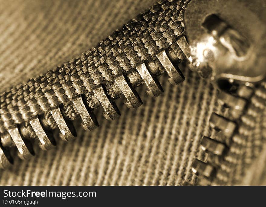 Closeup or macro of an open brown zipper. Closeup or macro of an open brown zipper