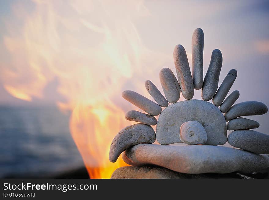 Symbol of Sun from the gravel in flames. Symbol of Sun from the gravel in flames