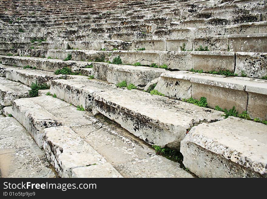 Close-up of ancient Greek amphitheatre stairs, background