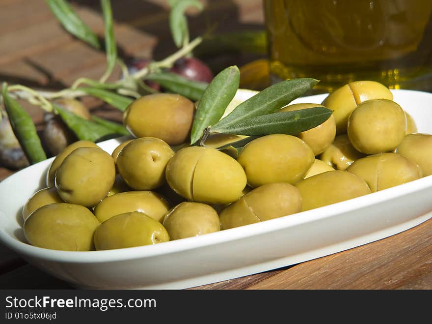 Fresh green olives and olive branch