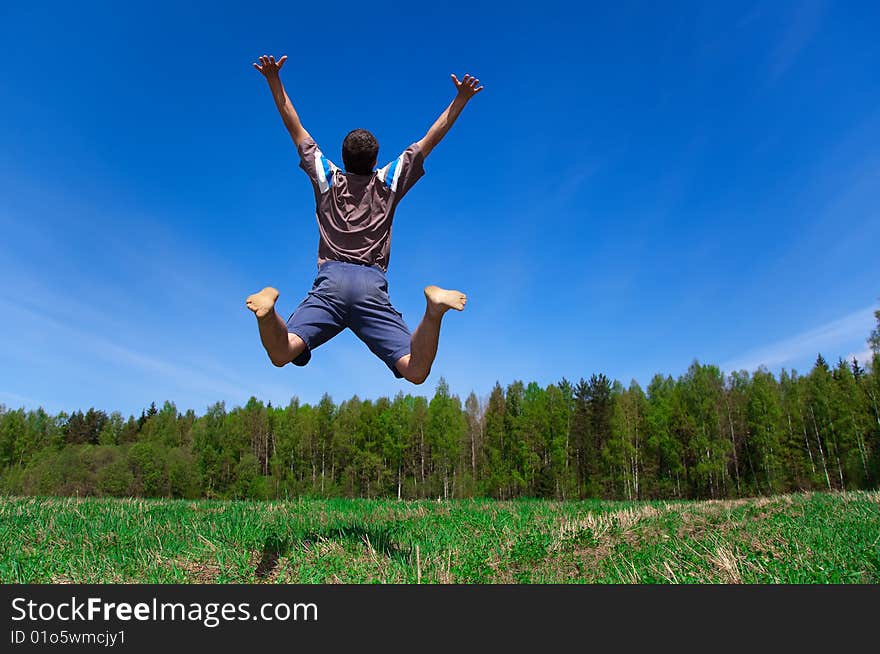 Man jumping against blue sky