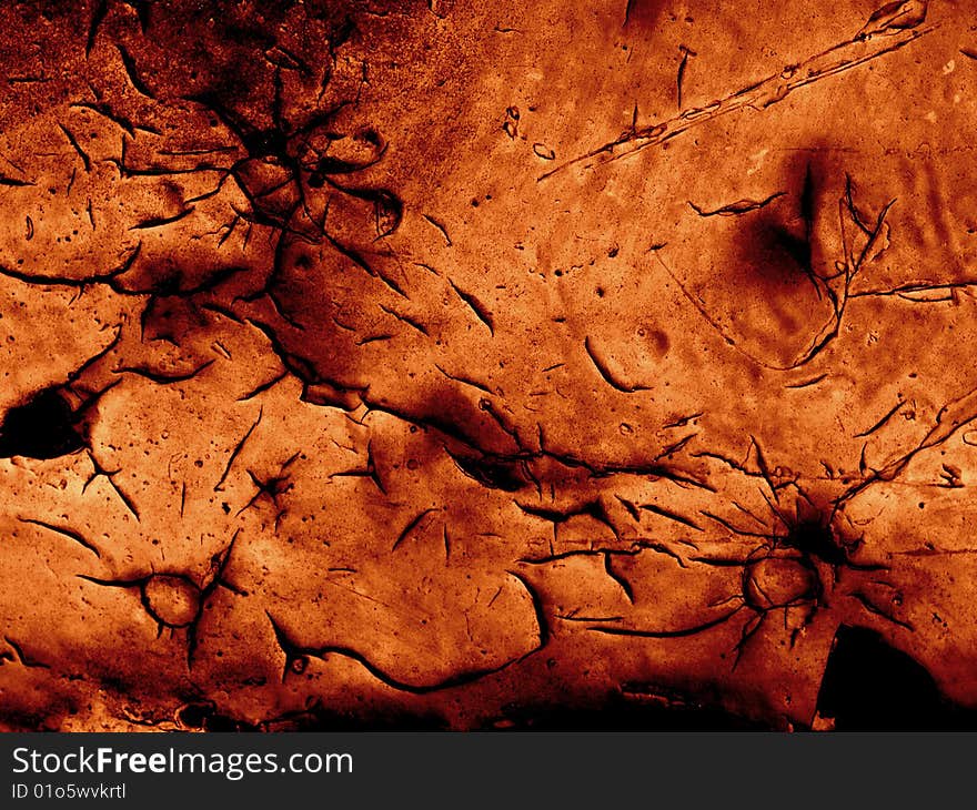 Grunge cracked paint - deep black cracks in thick orange paint