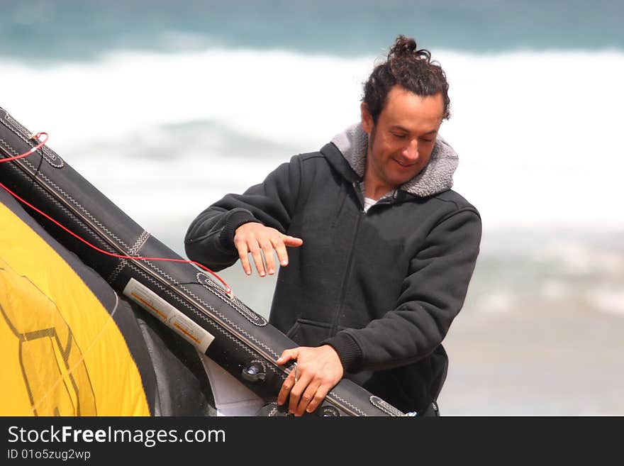 Kitesurfer preparing kite on beach