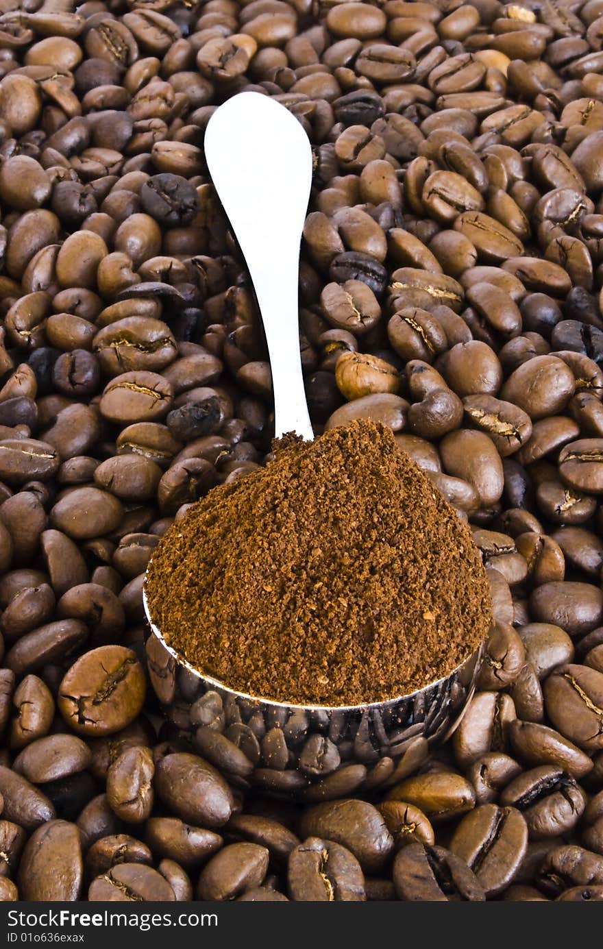 Spoon of coffee on a background grains