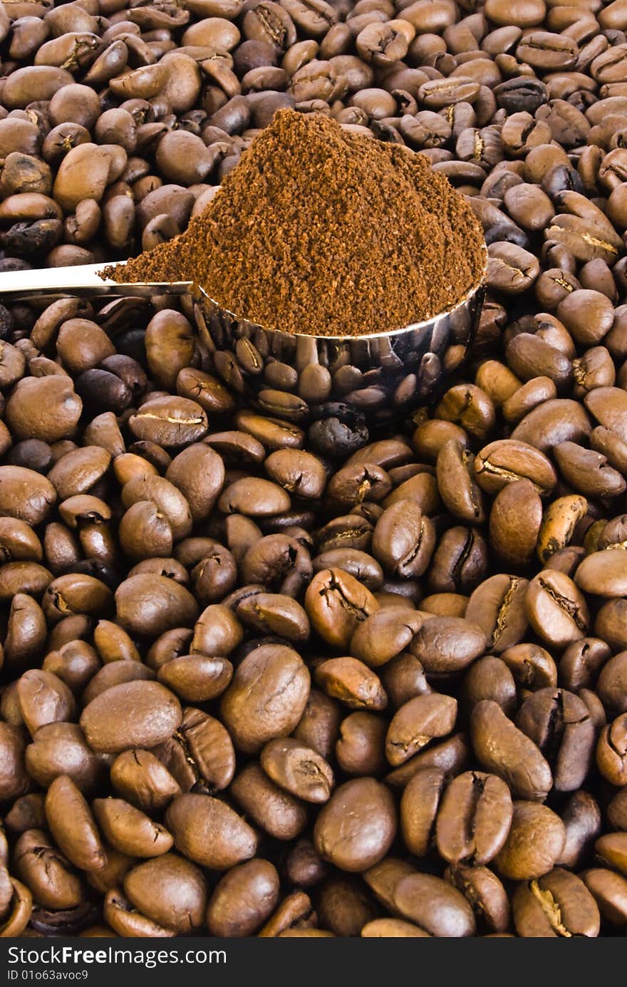 Spoon of coffee on a background grains