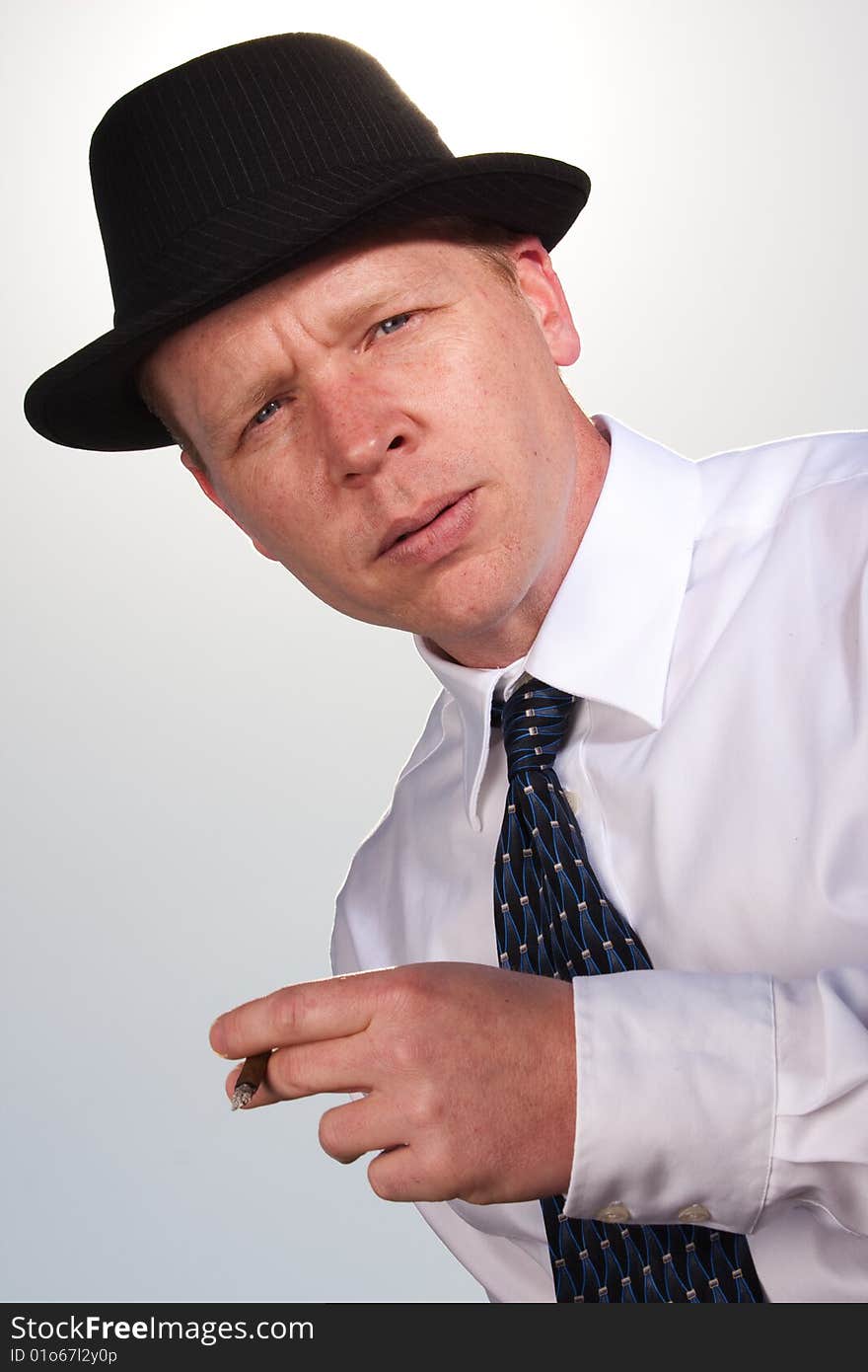 A man smoking and posing for the camera. A man smoking and posing for the camera