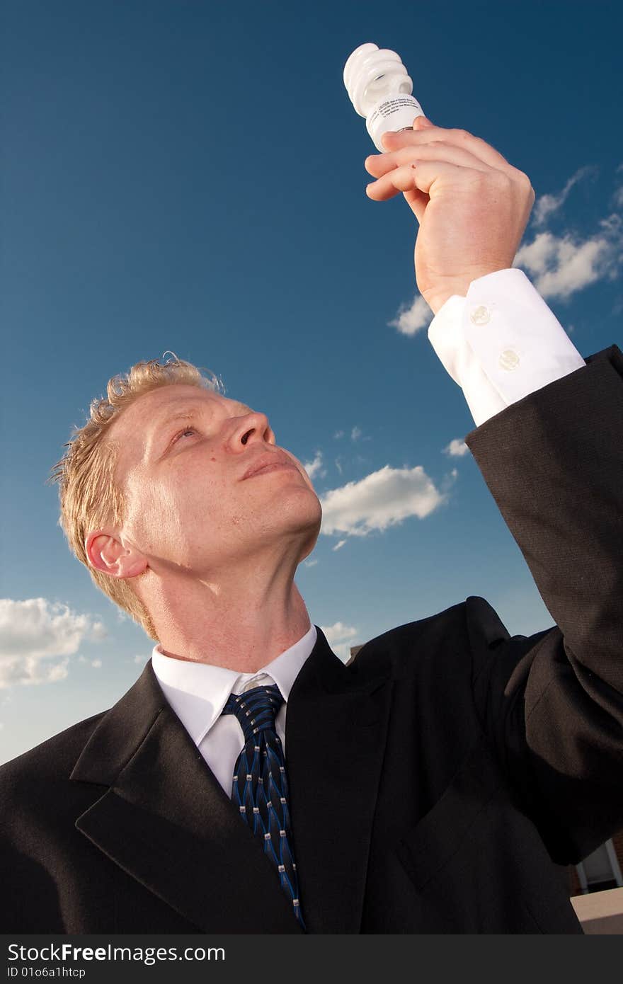 Businessman holding lightbulb