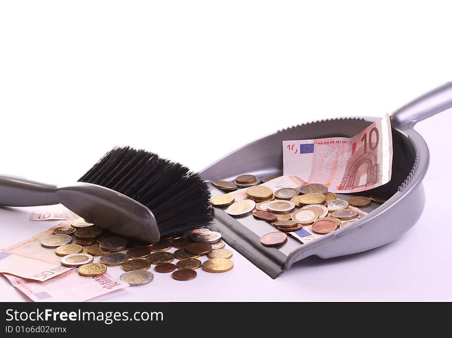 Dust pan and brush collecting money against a whithe background. Dust pan and brush collecting money against a whithe background