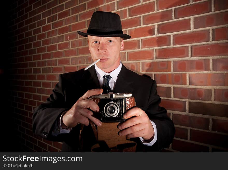 A man takes a photo with an old camera. A man takes a photo with an old camera