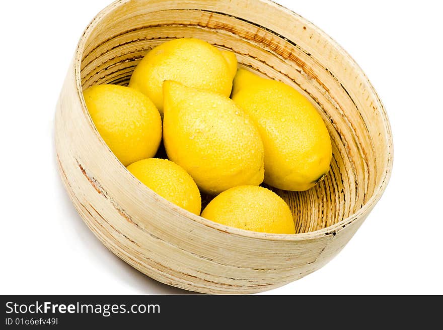 Wooden bowl of lemons