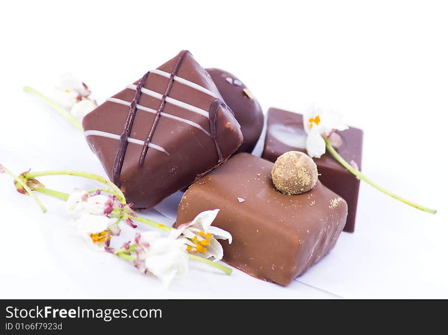 A selection of luxury chocolates with mini decorative flowers. A selection of luxury chocolates with mini decorative flowers