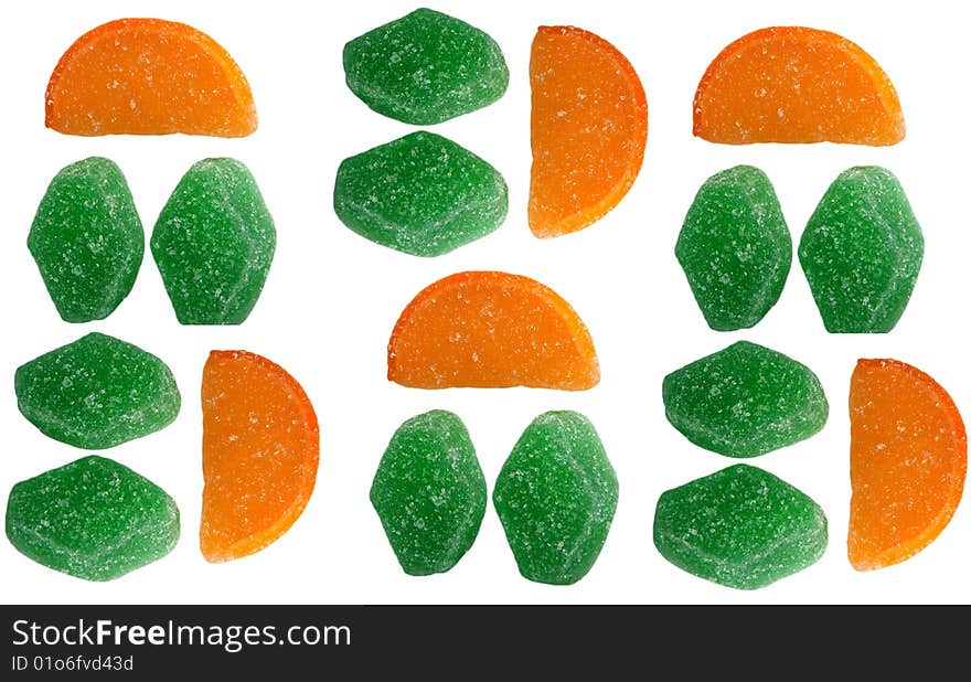 Fruit candy green and in the form of orange segments on a white background