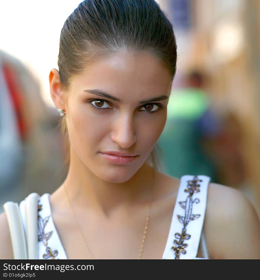 Portrait of the beautiful young woman in the street