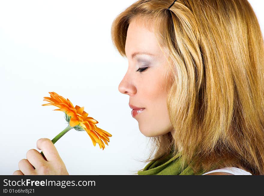 Beauty portrait of a smiling woman with a flower