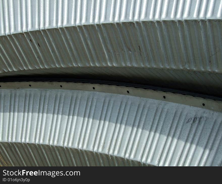 Curved corrugated steel material for a Quonset hut roof and siding.