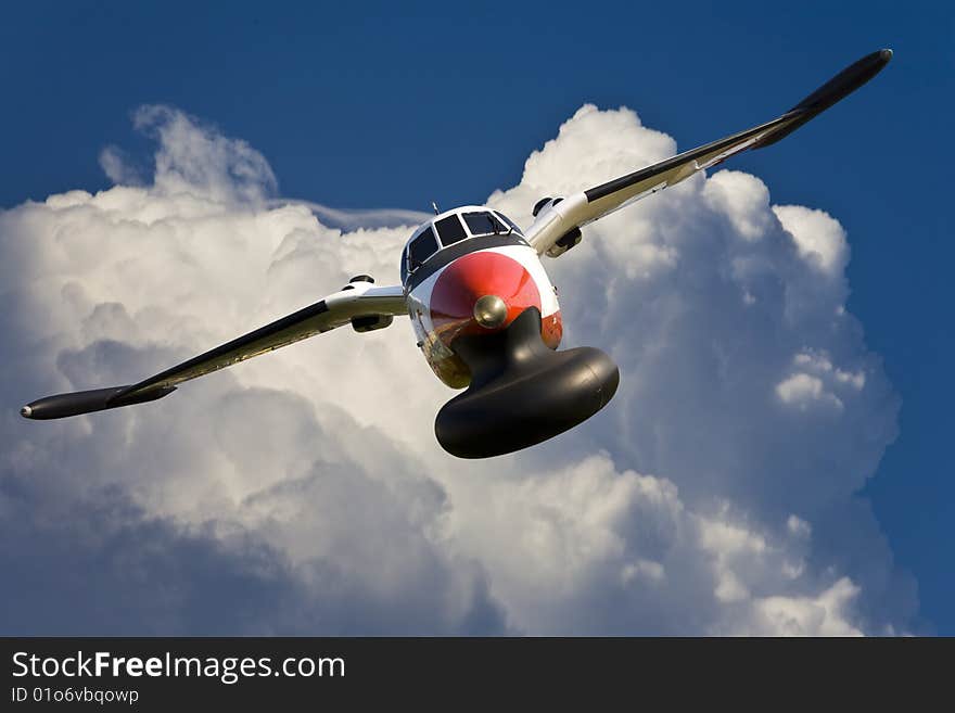 Front view of a reconnaissance plane from the sky as background