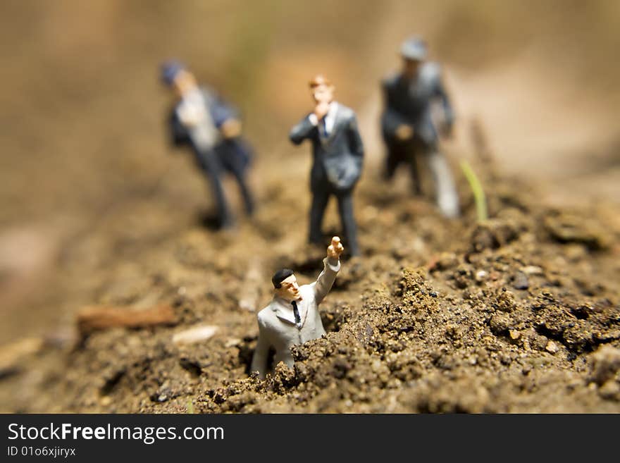 Business figurines placed outside in the dirt. Business figurines placed outside in the dirt