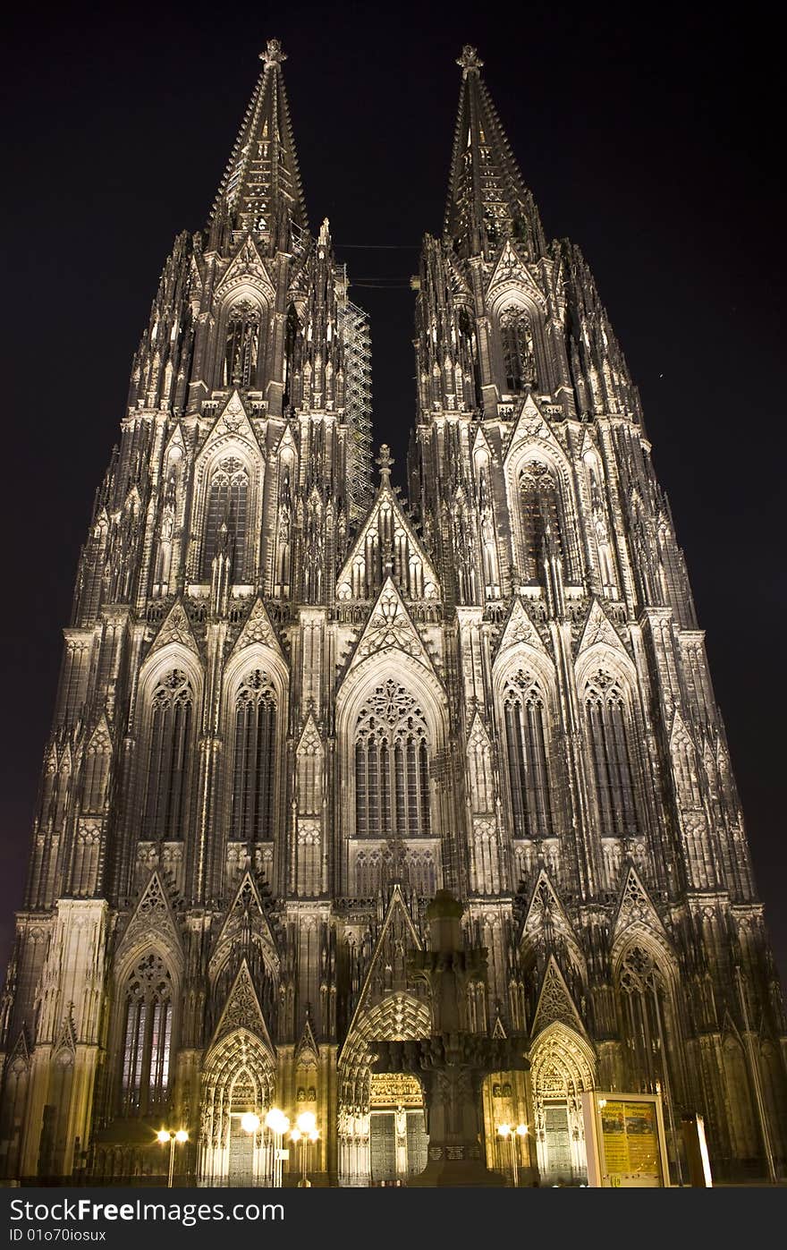 Main towers and portal of Dom in Cologne at night lighting.