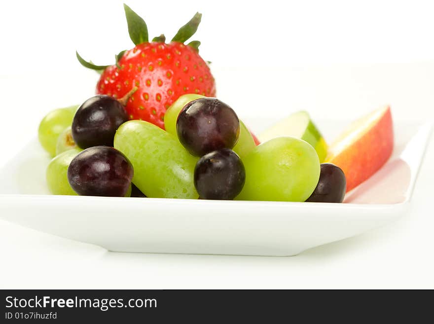 Fruit plate with strawberry, grape, mango and apple slices