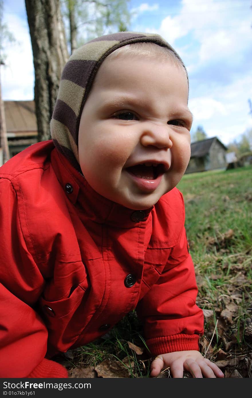 Little boy playing in leaves