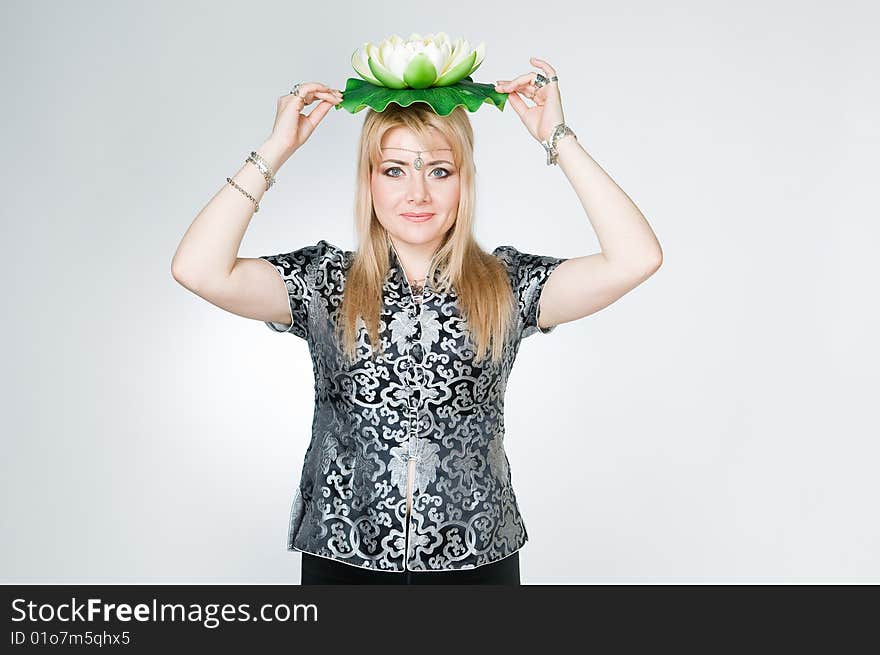 Woman with lotus flower, studio shot