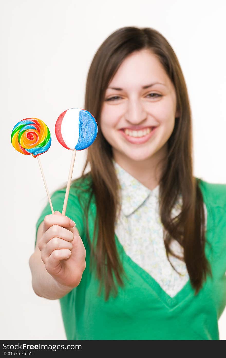 Young smiling girl with lollipops, focus on sweets