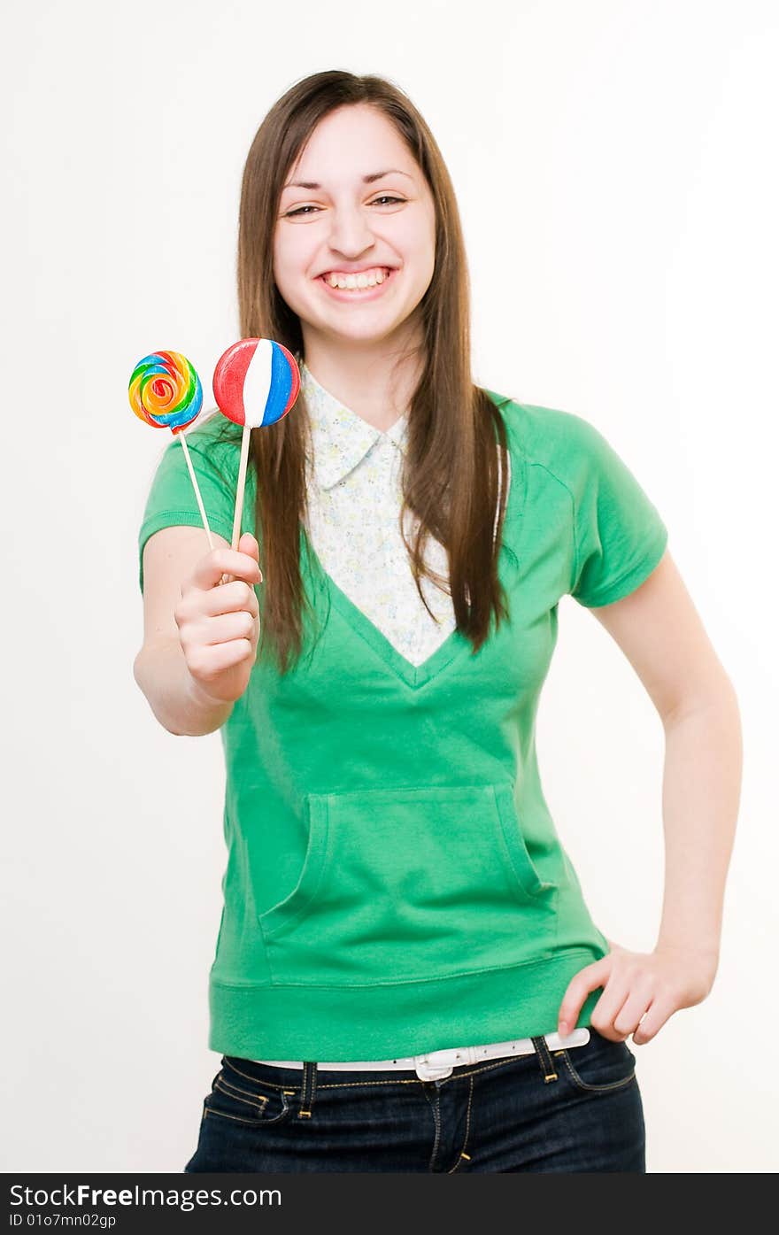 Smiling girl with lollipops, focus on sweets