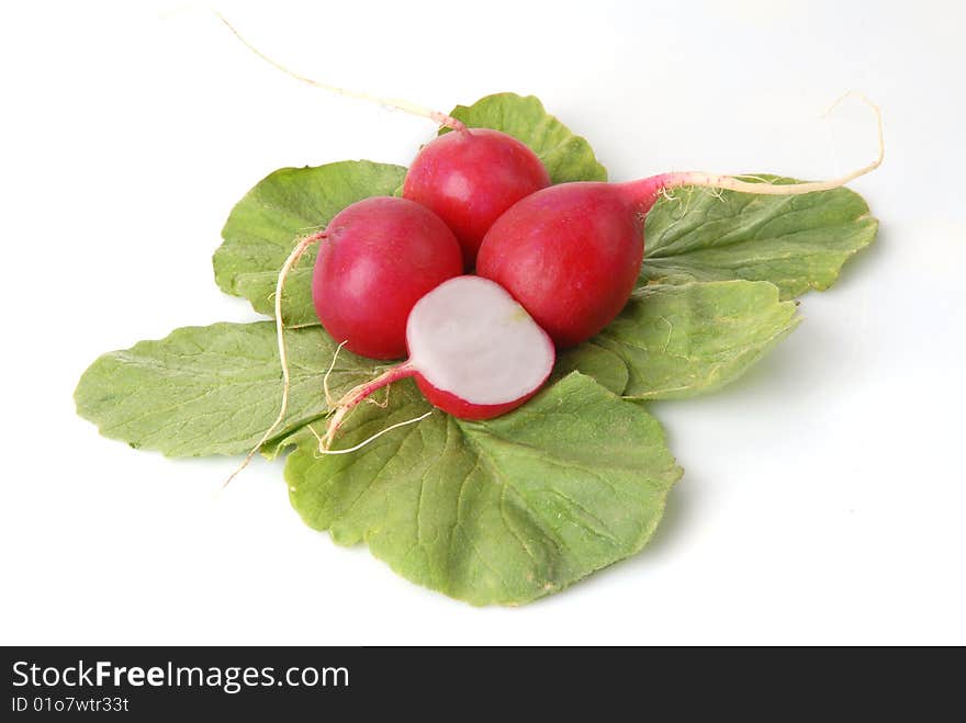 Half and whole a radish on a white background